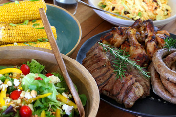 colourful barbeque braai plated meal consisting of chicken, steak, boerewors salad and coleslaw laid out and ready to eat on table