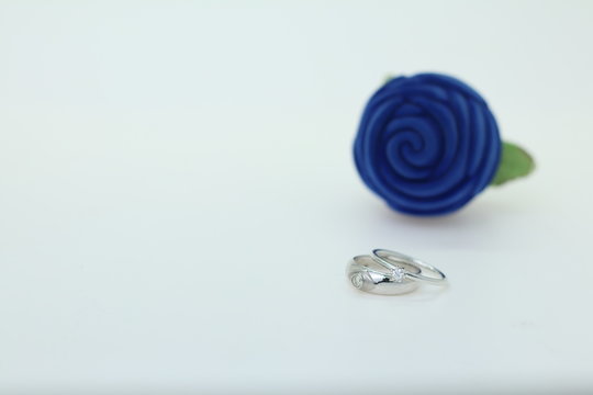 White gold diamond ring on Blue rose setting on the white background for copy space photo