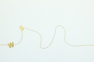 Gold necklace chain with letter on white background