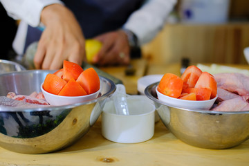 chef preparing tomato chicken meat.