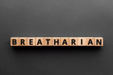 Breatharian - word from wooden blocks with letters, breatharians: The People Who Think Air Is Food, gray background