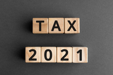 Tax 2021 - phrase from wooden blocks with letters, Tax time 2021 concept, top view gray background