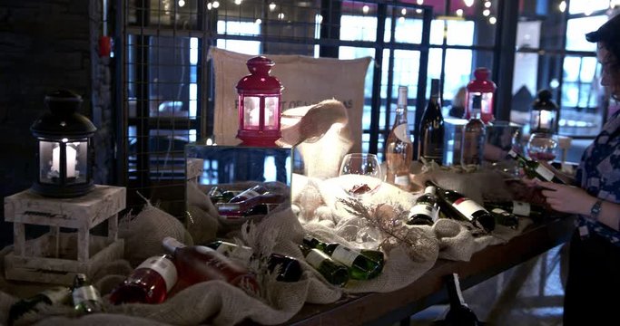 Girl examines wines in cafe