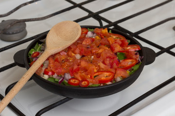 Vegetables stewed in pan on stove. Homemade food
