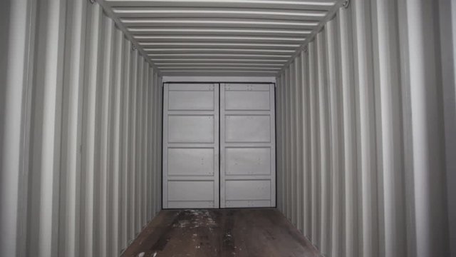 View inside of spacious empty cargo trunk of the truck with metal covering, transportation and trucking industry concept. Stock footage. Inside the metal container.