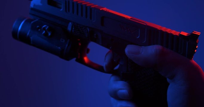 slowly squeezing the trigger of a handgun.
