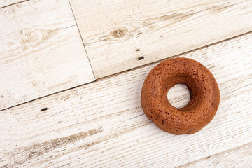 Chocolate chocolate donuts on a wooden background. Food is popular.