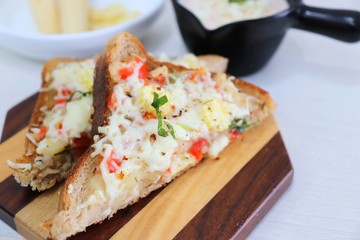 Chili Cheese toast, Open cheese sandwich or mini bread pizzas served with mayonnaise deep and garnished with chopped Basil leaves.