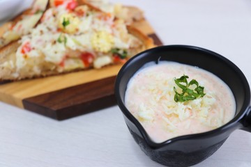 Chili Cheese toast, Open cheese sandwich or mini bread pizzas served with mayonnaise deep and garnished with chopped Basil leaves.