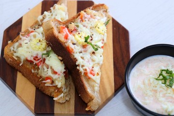 Chili Cheese toast, Open cheese sandwich or mini bread pizzas served with mayonnaise deep and garnished with chopped Basil leaves.