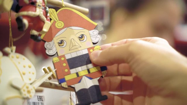 Wooden toy Nutcracker in men's hands.