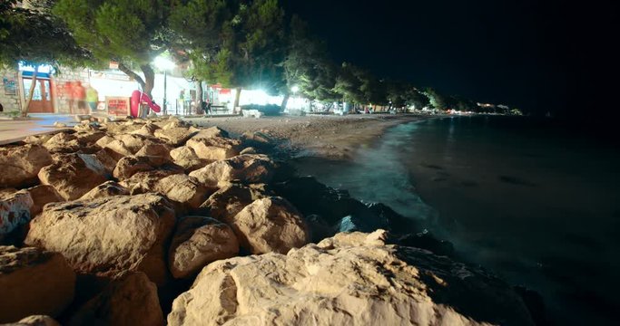 Tucepi, Croatia - Aug 18, 2018: Time Lapse 4K view of the sea line of the beach