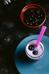 homemade blueberry smoothie on dark wooden table