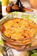 Potatoes baked with tomatoes and sweet peppers