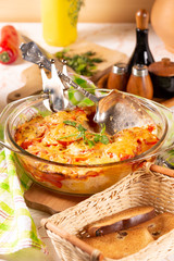 Potatoes baked with tomatoes and sweet peppers