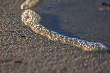 Fototapeta na wymiar seafoam and sand