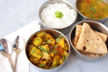 Stainless steel Lunch Box or Tiffin with Indian food menu Chapati or Roti, Garlic Dal Tadka, White...