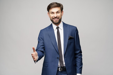 successful young businessman holding out his hand for a handshake