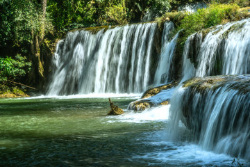 Waterfall in rainforest at National Park. Natural background.