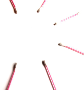 Pink Cotton swabs on a white isolated background. Copy space. View from above. Ear sticks.