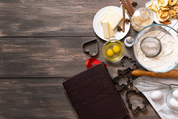 Cooking a delicious cake on table on a wooden background.