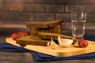 Still life from the meal vodka garlic bread smoked sausages