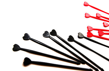 Black and red sticks for canapes whith heart on a white isolated background. Place for text.
