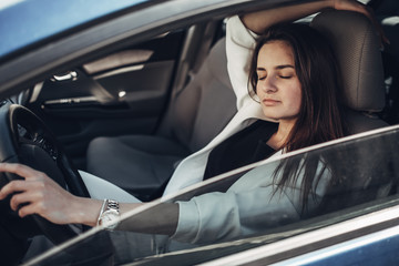 Fototapeta na wymiar Fashion Stylish Driver Girl in White Suit Sitting in the Car