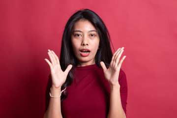 Shocked young Asian woman.