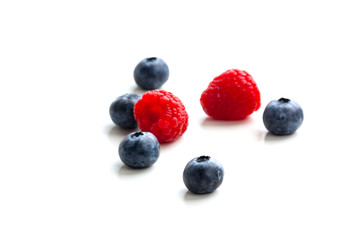 blueberries and raspberries isolated on white