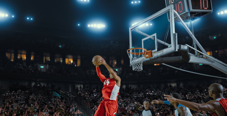 Basketball players on big professional arena during the game. Tense moment of the game. Celebration
