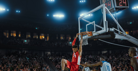 Basketball players on big professional arena during the game. Tense moment of the game. Celebration