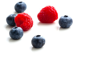 blueberries and raspberries isolated on white