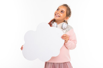 Little beautiful girl with brown hair holds a white card and smiles