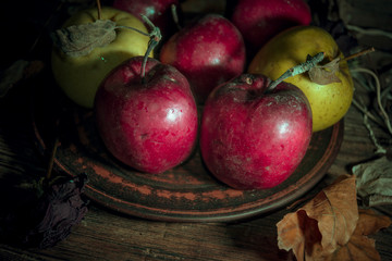 Fresh autumn apples on rural wooden background, natural rough fruit surface