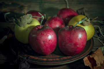 Fresh autumn apples on rural wooden background, natural rough fruit surface