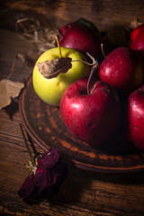 Fresh autumn apples on rural wooden background, natural rough fruit surface