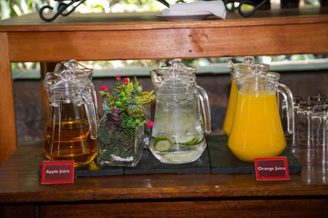 jugs of water orange and apple juice