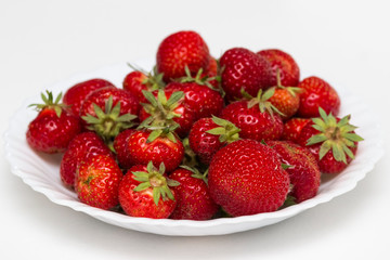 Fresh strawberries on a white plate