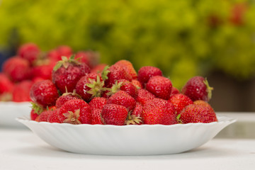 Fresh strawberries on a white plate