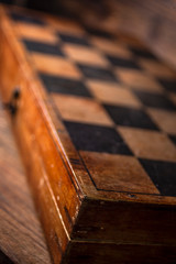 Old vintage wooden chess and a shabby chessboard