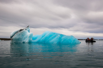 Icebergs with volcanic ash layers floating on water in a glacier lagoon