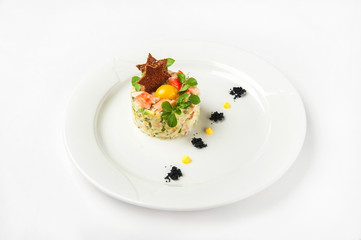 Meat salad in a restaurant close-up. Olivier salad with bread and egg on a white plate and copy space.