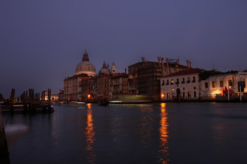 Italy, Venice by night with boats passing by