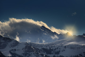 Fototapeta na wymiar Swiss mountais with clouds and blue sky