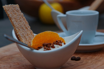 coffe and fruit yoghurt on wooden background