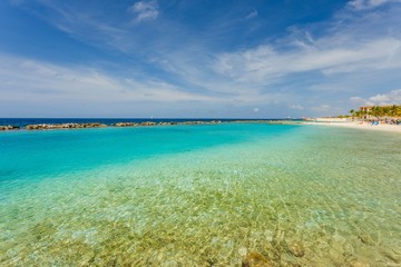 Amazing view of turquoise water of Atlantic ocean and blue sky with white clouds. Curacao island.. Beautiful nature background.
