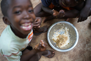Happy Little African Boys Enjoying Their Simple Rice Meal