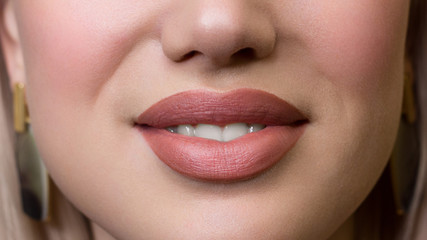 Naklejka premium Smiling young girl. Beauty face closeup. Sexy lips. Beauty natural lip makeup detail. Beautiful make-up close-up. Sensual open mouth with teeth. Lipstick and lipgloss