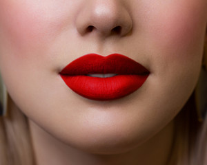 Cosmetics, makeup and trends. Bright lip gloss and lipstick on lips. Closeup of beautiful female...